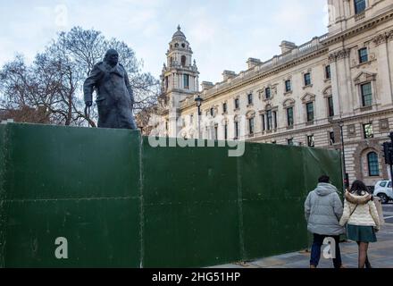 The statue of former Prime Minister Winston Churchill is seen boarded up in Parliament Square, London, on News Year's Eve. Stock Photo