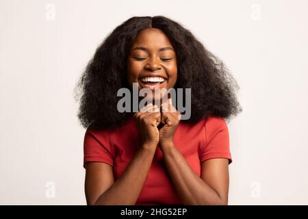 Pure Joy. Portrait Of Delighted Young Black Lady Posing Over White Background Stock Photo