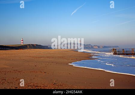A view of the beach from Cart Gap on a sunny and hazy morning in winter on the North Norfolk coast at Happisburgh, Norfolk, England, United Kingdom. Stock Photo
