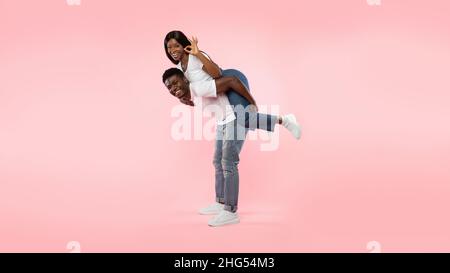 Happy black couple gesturing okay and having fun Stock Photo