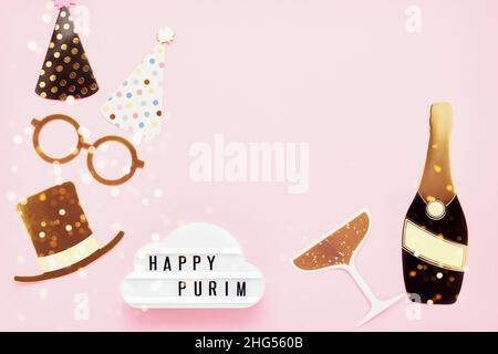 Jewish holiday Purim concept. Fun party props and lightbox with Happy Purim on a light pink background. Flat lay, copy space for text Stock Photo