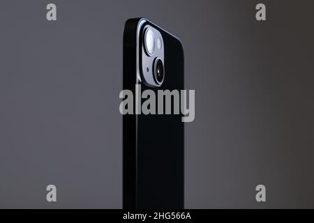 modern rectangular black smartphone on with straight edges and two large cameras on a gray isolated background Stock Photo