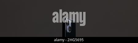 black modern smartphone with rectangular edges and two cameras on a gray background Stock Photo