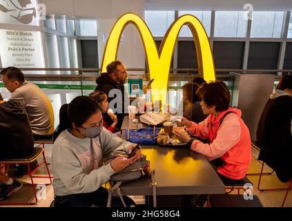 Customers Are Seen Eating In A Restaurant Partitioned In Order To 