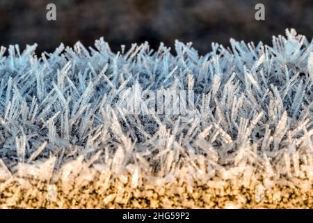 Close-up macro photograph of frost on a wooden gate on a cold winter morning. Stock Photo