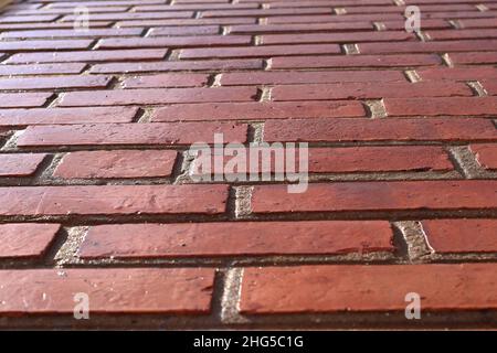 Perspective red shiny brick wall, wide panorama of masonry, bricklaying Stock Photo
