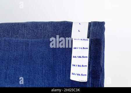 Blue jeans denim with label size, collection jeans stacked with label size, size tag on Blue jeans denim pants. Stock Photo