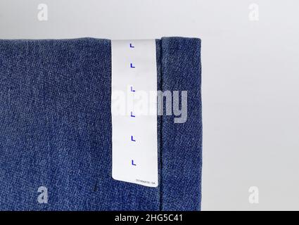 Blue jeans denim with label size, collection jeans stacked with label size, size tag on Blue jeans denim pants. Stock Photo