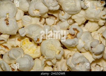 White popcorn kernels up close with details and textures from directly above, selective focus. Stock Photo