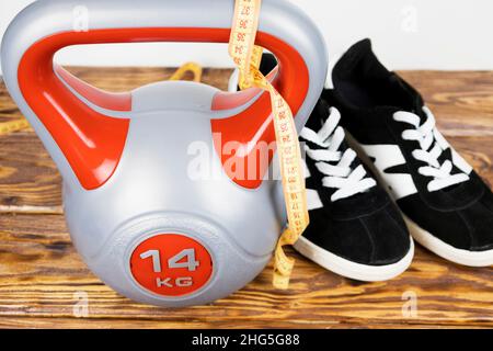 a sports kettlebell on a wooden background. Healthy lifestyle Stock Photo