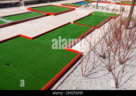 green artificial grass and rocks on miniature golf course Stock Photo