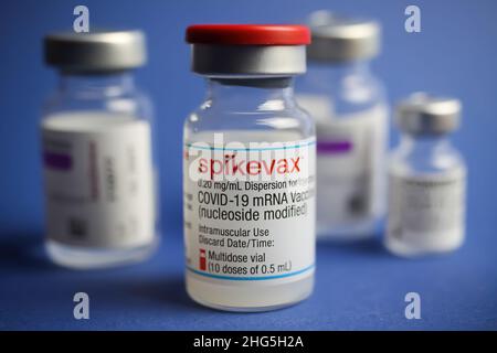 Viersen, Germany - January 9. 2022: Closeup of group vials covid-19 vaccination serum, blue background Stock Photo