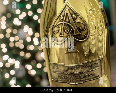 Armand de Brignac 'Ace of Spades'' CHAMPAGNE fine luxury distinctive metallic gold champagne bottle with sparkling celebration lights behind Stock Photo