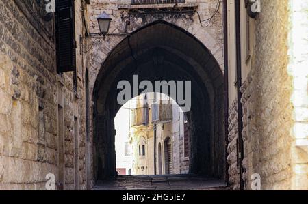view of alley with arch in the old town of Trani, Puglia, Italy Stock Photo