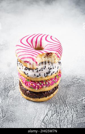 Stack of artisan donuts. White background. Top view. Copy space Stock Photo