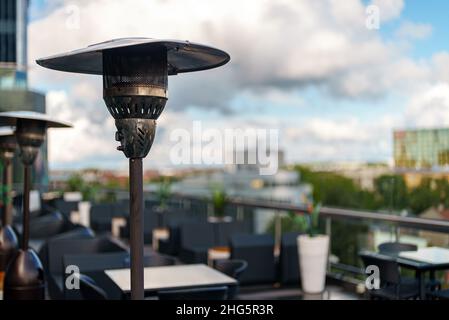 Stainless stand up outdoor gas heater in cafe. Stock Photo