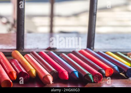 Focused crayon color diversity and hand picking up a brown crayon ,copy space Stock Photo