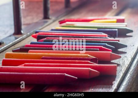 Focused crayon color diversity and hand picking up a brown crayon ,copy space Stock Photo