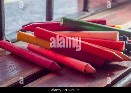 Focused crayon color diversity and hand picking up a brown crayon ,copy space Stock Photo