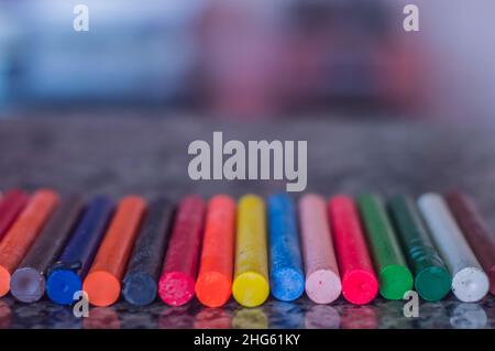 Focused crayon color diversity and hand picking up a brown crayon ,copy space Stock Photo