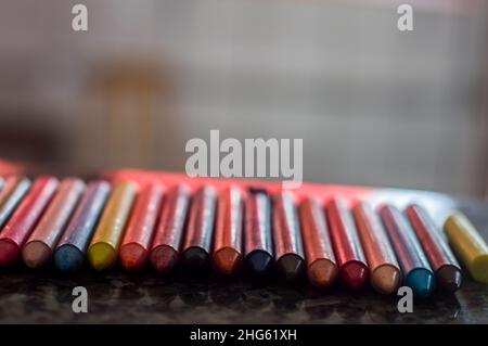 Focused crayon color diversity and hand picking up a brown crayon ,copy space Stock Photo