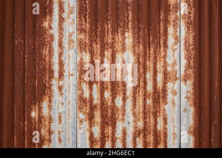 Full frame shot of a weathered and rusty corrugated iron roof, suitable as a industrial background texture Stock Photo