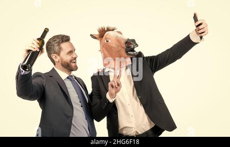 Happy professional men stream selfie video via mobile phone from corporate party, livestreaming Stock Photo