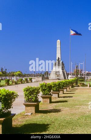 The Rizal Monument is a memorial in Rizal Park in Manila, the Philippines, built to commemorate the executed Filipino nationalist, José Rizal. The monument consists of a standing bronze sculpture of Rizal, with an obelisk on a stone base within which his remains are interred. The monument is guarded continuously by the Philippine Marine Corps. 100 metres northwest of the monument is the exact location where Rizal was executed, a spot now marked by dramatic life-size statues depicting his final moments before a firing squad. Stock Photo