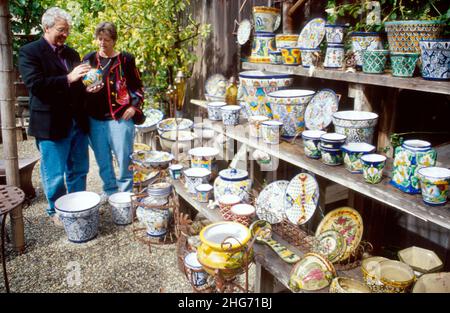 Monterey California,Carmel Valley Village,man male,woman female couple,shopping selling retail store ceramic bowls display Mexican Talavera pottery Stock Photo