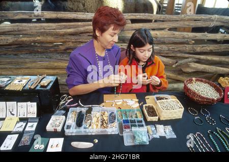 Saskatoon Canada,Wanuskewan Native Heritage Park Cree Nation,indigenous people mother parent girl daughter,selling beadwork making bracelets necklaces Stock Photo