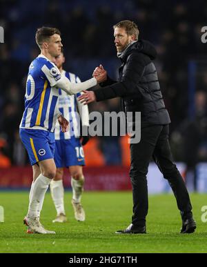 Brighton and Hove, England, 18th January 2022. Graham Potter, Manager of Brighton and Hove Albion (right) shakes hands with Solly March of Brighton and Hove Albion (left) after the Premier League match at the AMEX Stadium, Brighton and Hove. Picture credit should read: Kieran Cleeves / Sportimage Stock Photo