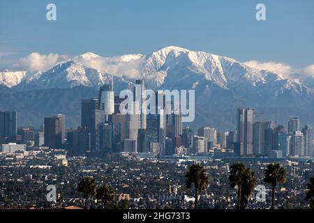 Skyline of downtown Los Angeles on a clear day with the San Gabriel Mountains and Mt. Baldy covered in snow Stock Photo