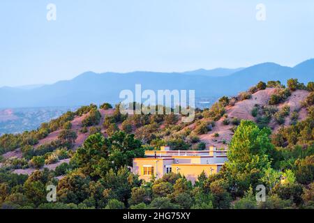 High desert mountain house home during summer sunset and twilight blue hour in Santa Fe, New Mexico Stock Photo