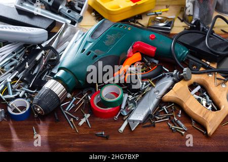 Different screws and tools on the table in the workshop Stock Photo