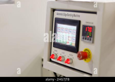 Control panel of automatic edge banding machine. Selective focus. Stock Photo