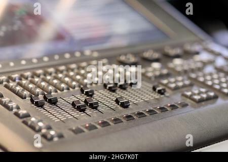 Faders and keys on the lighting control console. Selective focus. Stock Photo