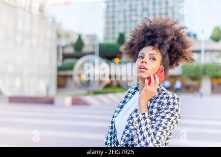distracted woman looking away while talking on the phone Stock Photo