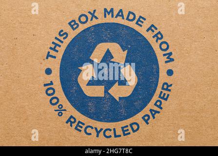 Cardboard Box with Blue Recycle Symbol Background. Stock Photo