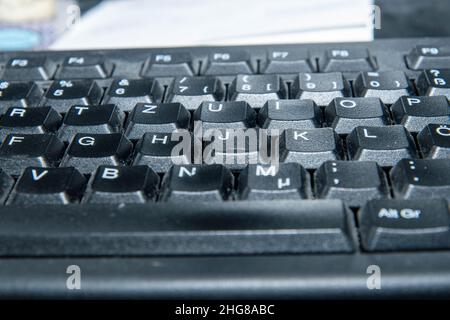 dusty computer keyboard in the home office Stock Photo
