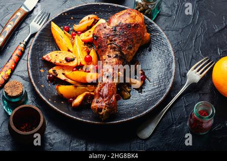 Appetizing turkey leg fried with oranges and spices Stock Photo