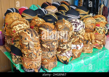 A blangkon or belangkon (in Indonesian) is a traditional Javanese headgear worn by men and made of batik fabric. There are four types of blangkons. Stock Photo