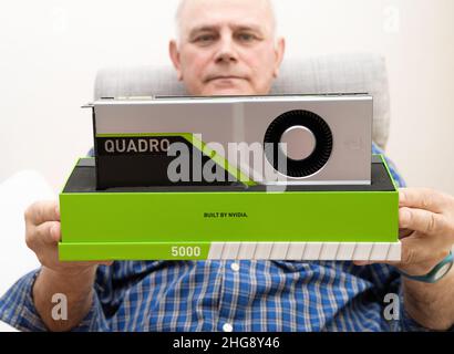 Paris, France - Mar 28, 2019: Senior engineer hands pov holding looking at new GPU Nvidia Quadro RTX 5000 based on the Turing microarchitecture, and features real-time ray tracing Stock Photo
