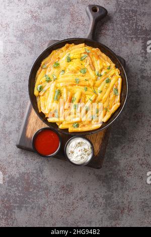 Chipsi mayai or zege is the most popular street food found all over Tanzania is a simple potato egg omelette close up in the plate on the table. Verti Stock Photo