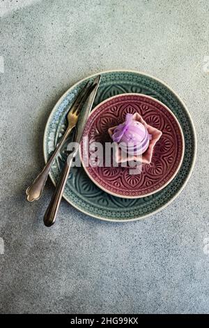 Festive Easter place setting decorated with a painted Easter egg Stock Photo