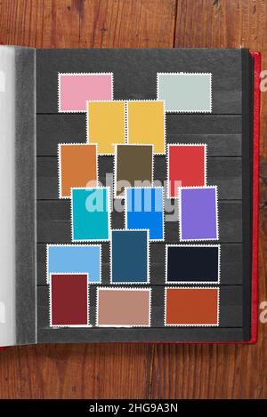 Postage stamps frames set in vintage album on wooden table Stock Photo