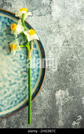 Narcissus flower on a ceramic plate Stock Photo