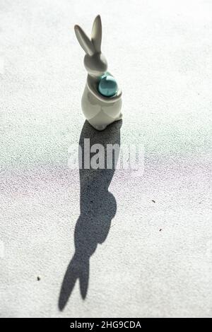 Easter bunny decoration casting a shadow on a table Stock Photo