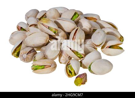 Closeup of roasted salted pistachios pile isolated on a white background. Pistacia vera. Yummy green pistachio cores in beige open split halved shells. Stock Photo