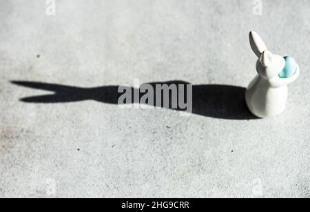 Easter bunny decoration casting a shadow on a table Stock Photo