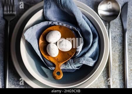 Overhead view of a festive place setting with Easter eggs Stock Photo